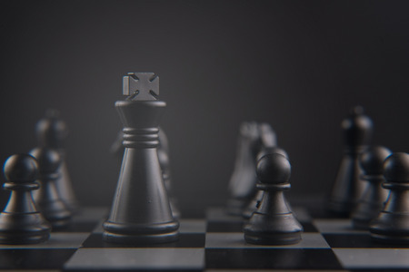 chess set on chess board. black king and pawn pieces. leader, strategy and teamwork concept. selective and soft focus.の写真素材