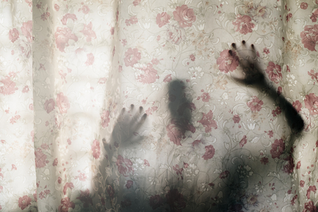 Mysterious human shadow behind a curtain. fear, Mystery, scary, creepy and paranormal conceptの写真素材