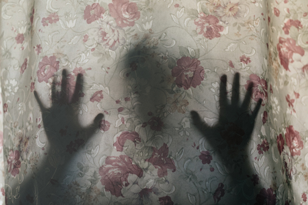 Mysterious human shadow behind a curtain. fear, Mystery, scary, creepy and paranormal conceptの写真素材
