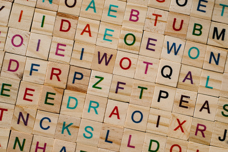 close up of a wooden alphabet tiles as a background. educational concept