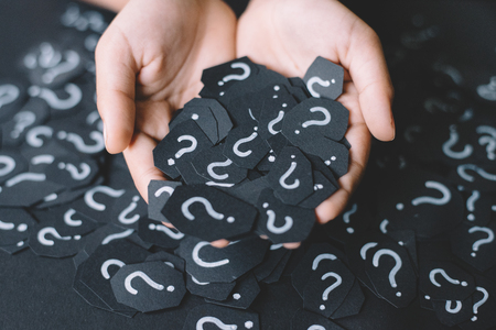 hand showing paper with QUESTION MARK. Concept of FAQ, Q&A, problems, mytery and questions