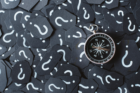 Compass with moving rod on question mark background. Concept of travel, navigation, explore and where to goの写真素材