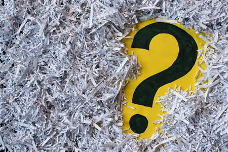 Question mark symbol in a shredded paper. Concept of confidential office paperwork, faq and...