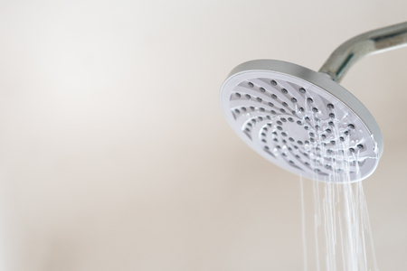 Leaking water from a shower head. Concept of water wastageの写真素材