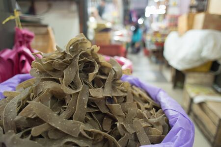 Malaysian traditional raw Fish Cracker known as KEROPOK KEPING in a market for sale. の写真素材