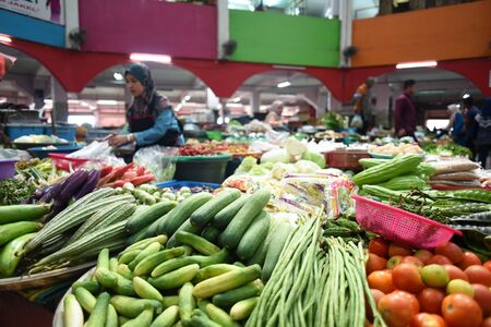 Kota Bharu, Kelantan, Malaysia - 14 August 2019 : farmers selling various vegetables in a farmers market located in Pasar Siti Khadijah, kota bharu, kelantanのeditorial素材