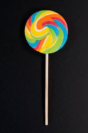 Swirl round lollipop on black background. concept of unhealthy food,sweets and candy dayの写真素材