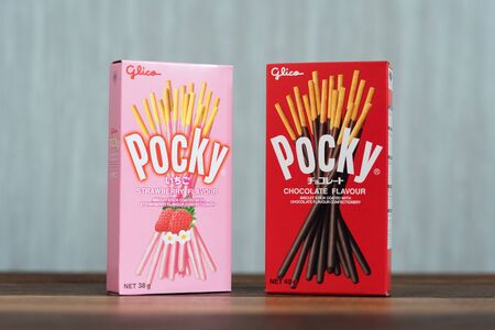 Petaling jaya, Selangor, Malaysia - 20 Oktober 2019 : Pocky brand of chocolate sticks on wooden table. Pocky is a famous confectionery among asian peopleのeditorial素材