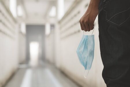 man holding a surgical mask outdoors. Concept of pandemic, virus outbreak and health careの写真素材