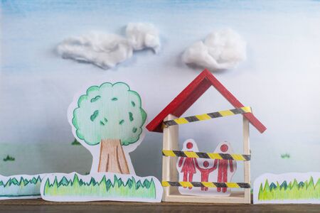 Hand drawn of trees, grass and a family inside a house. Concept of Lockdown in a global crisis pandemicの写真素材