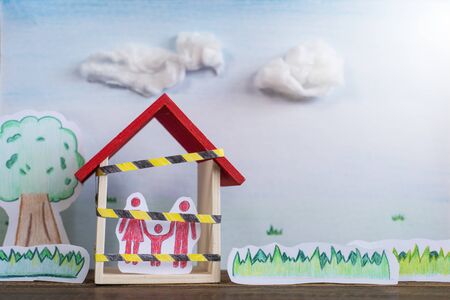 Hand drawn of trees, grass and a family inside a house. Concept of Lockdown in a global crisis pandemic with copy spaceの写真素材