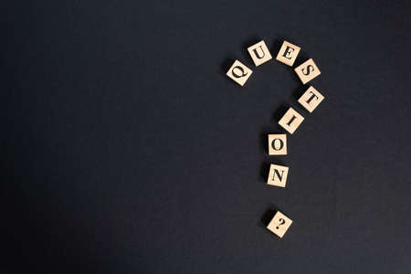 question mark word tiles arranged forming bigger question mark. question mark on black backgroundの写真素材