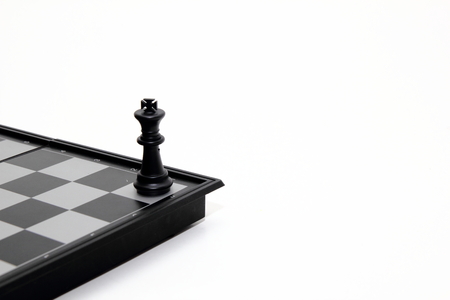 Chess piece on chess board on white backgroundの写真素材