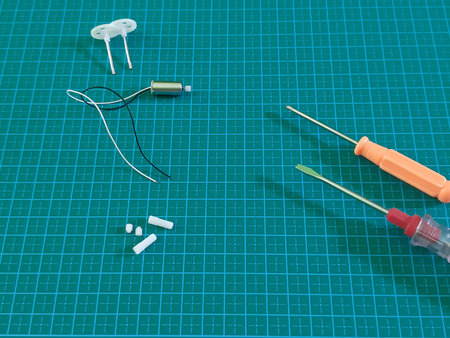 Screwdriver with gear and toys motor on cutting mat backgroundの写真素材