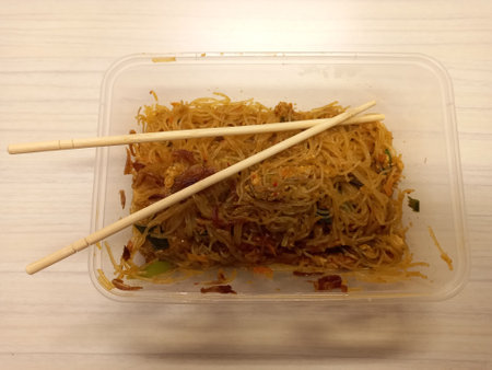 Vermicelli fried or called bihun goreng served in a plastic box with top view photoの写真素材