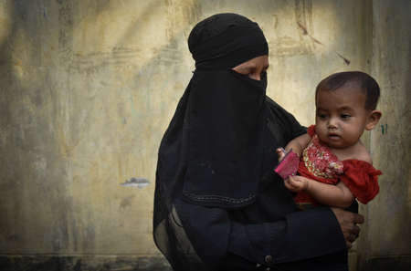 COX' BAZAR, BANGLADESH - APRIL 15, 2020 : Rohingya refugees, mother and child from Myanmar in Kutupalong refugee camp near Cox's Bazar, Bangladesh.のeditorial素材