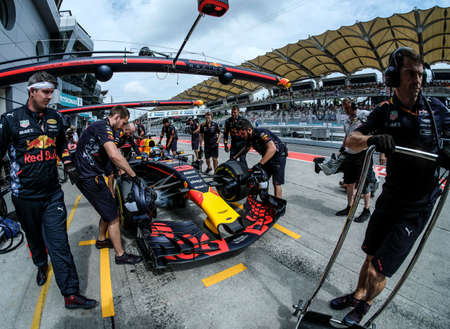 KUALA LUMPUR, MALAYSIA - SEPTEMBER 28, 2017 : Mechanics attend to Red Bull Racing driver Daniel Ricciardo car during Malaysia Formula One Grand Prix at Sepang Circuit.のeditorial素材