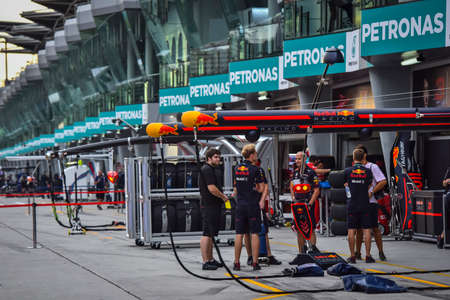 KUALA LUMPUR, MALAYSIA - SEPTEMBER 28, 2017 : Team mechanics work on Red Bull Racing car during Malaysia Formula One Grand Prix at Sepang Circuit.のeditorial素材