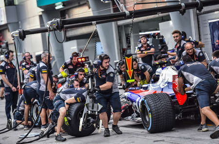 KUALA LUMPUR, MALAYSIA - SEPTEMBER 28, 2017 : Team mechanics work on Scuderia Toro Rosso car during Malaysia Formula One Grand Prix at Sepang Circuit.のeditorial素材