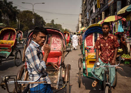 DHAKA, BANGLADESH - SEPTEMBER 17, 2019 : Traditionally ornamented cycle rickshaws presents a very...