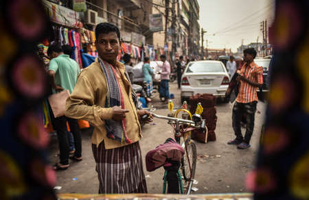 DHAKA, BANGLADESH - SEPTEMBER 17, 2019 : Traditionally ornamented cycle rickshaws presents a very...