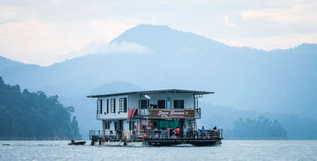 TERENGGANU. MALAYSIA - SEPTEMBER 15, 2019 : Beautiful houseboat crusing through the lake with...
