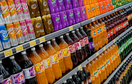 KUALA LUMPUR, MALAYSIA - SEPTEMBER 15, 2019 : Variety of sweet drink bottle and can on the shelf at supermarket.のeditorial素材