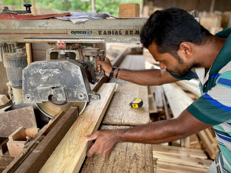 Kuala Lumpur, Malaysia - May 08, 2020 : A man foreign worker from Bangladesh working at the wood factory.のeditorial素材