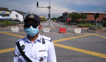PETALING JAYA, MALAYSIA - MAY 8, 2020 : Malaysia Police officer control the road near wet market...