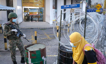 PETALING JAYA, MALAYSIA - MAY 14, 2020 : Malaysia soldier officer control the road Jalan Pudu during...
