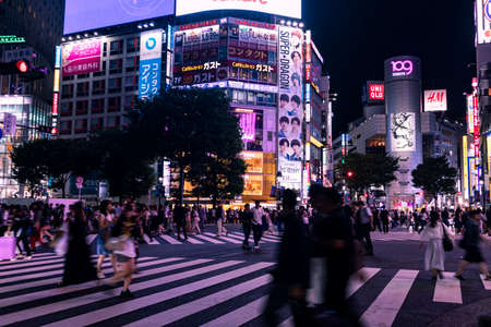 TOKYO, JAPAN - August 20, 2019 : Shibuya Scramble Crossing at night. Motion blur. Selective Focus.のeditorial素材