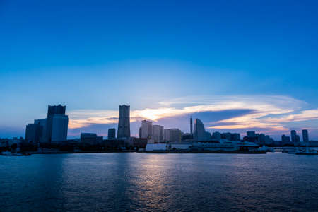 Ray of light above the city skyline in Minato Mirai, Yokohama just before the sunset.のeditorial素材