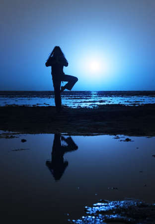 woman streching on the shore の写真素材