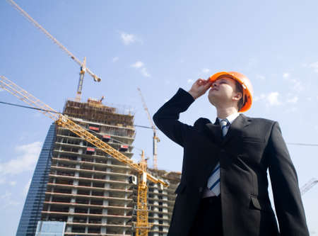 foreman looking to construction buildingの写真素材