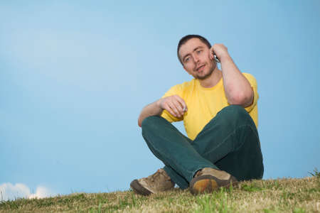 smoking man sitting on the grass