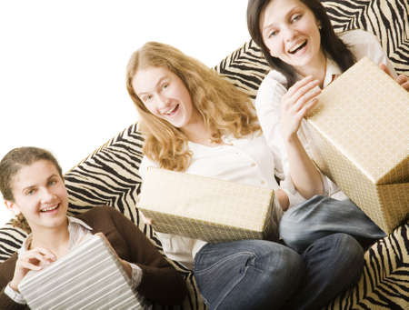 three girls on the sofa with giftsの写真素材