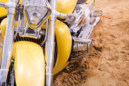 Yellow excellent motorbike on sandの写真素材