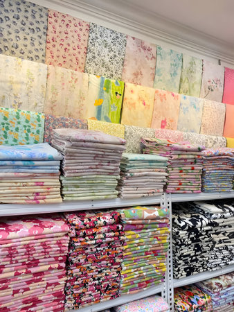 Stacks of vibrant fabrics on shelves in a textile store