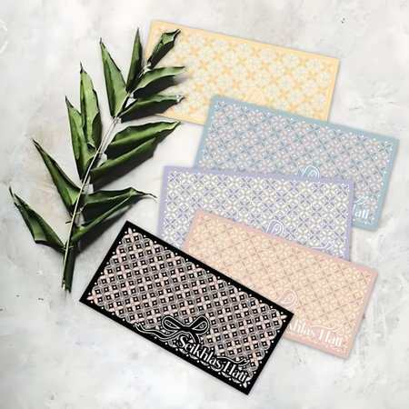 High-end fabric samples arranged with green leaves on a marble surface