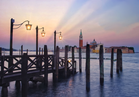 Pier in Venice at twilight with glowing lights and beautiful skyの写真素材