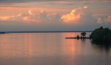 Beautiful clouds and colorful water in lake reflected in evening. Summer landscapeの写真素材