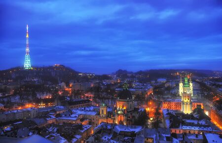 Aerial panoramic night view of High Castle hill with TV tower, Dominican Monastery, Korniakt Tower and old quarters in historical city center at night, Lviv, Ukraine.の写真素材