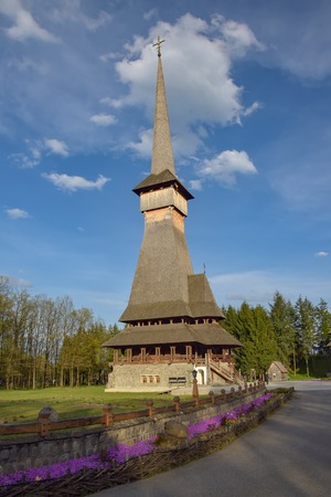 Traditional Maramures neo-gothic wooden church in Sapanta-Peri monastery with highest wooden belltower in Europe, Romaniaの写真素材