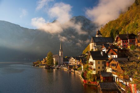 Scenic view of famous Hallstatt mountain village in the Alps under picturesque clouds at autumn morningの写真素材
