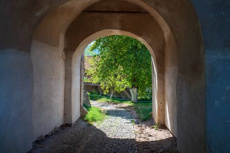 The court of fortified church in Biertan, Romania and Lutheran fortified church on backgroundの写真素材