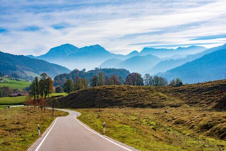 Winding road in mountain valley at autumn. Bavarian Alps, Germanyの写真素材