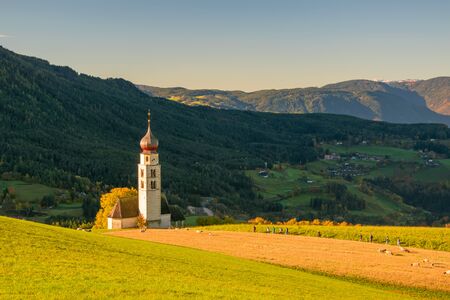 Traditional Tyrol church in the foothills of the Dolomites on rural mountain background. South Tyrol, Italyの写真素材