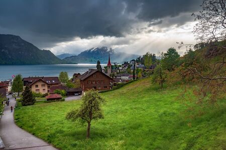 Village Weggis on Lucerne lake under dramatic clouds, Switzerlandの写真素材