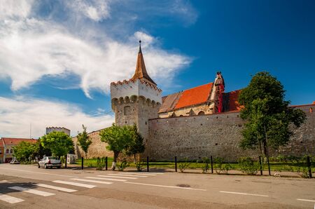 Scenic view of Aiud Citadel with tower, defensive wall and calvinist church against a cloudless sky at sunny summer day, Aiud, Alba County, Transylvania, Romaniaの写真素材
