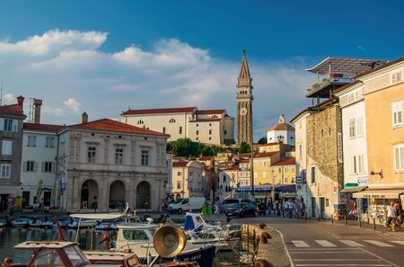 Piran, Slovenia - August 3, 2018: Harbour of Piran, Slovenia. Historic old buildings and St. George's Parish Church with italian campanile on the hill. Piran ia a popular sea resort on Adriatic coastのeditorial素材